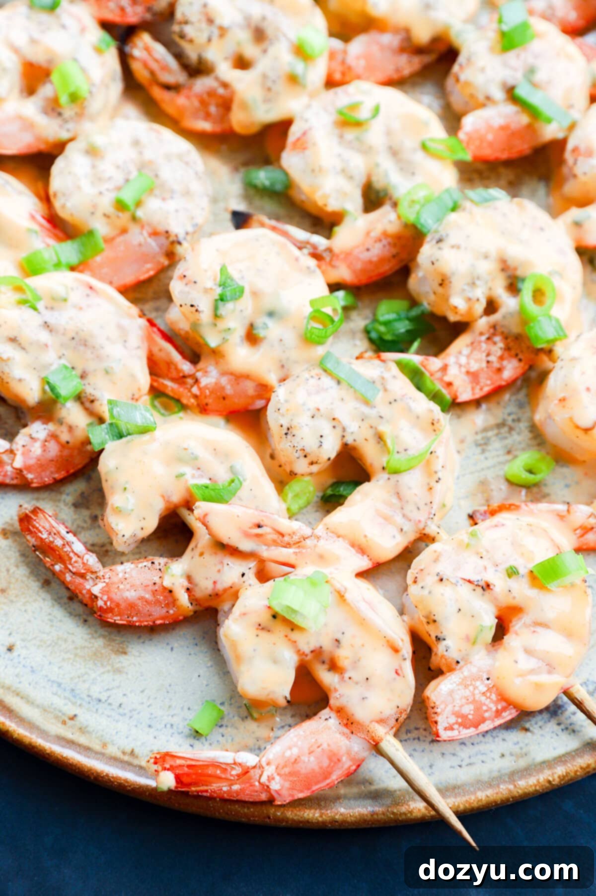 Sizzling Bang Bang Prawns 12 Easy grilled seafood skewers with sauce and green onion on top