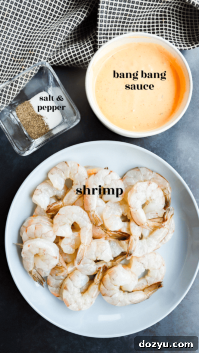 Sizzling Bang Bang Prawns 4 A collection of ingredients for grilled bang bang shrimp laid out in separate bowls