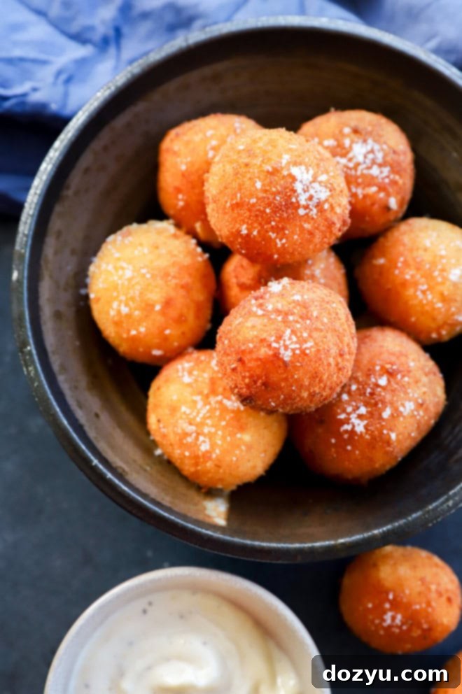 Bowl of fried cheese croquettes in a stack