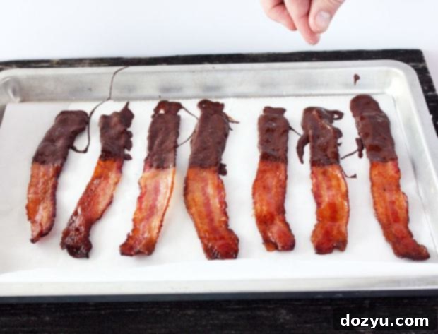 Close-up of chocolate covered bacon on a platter