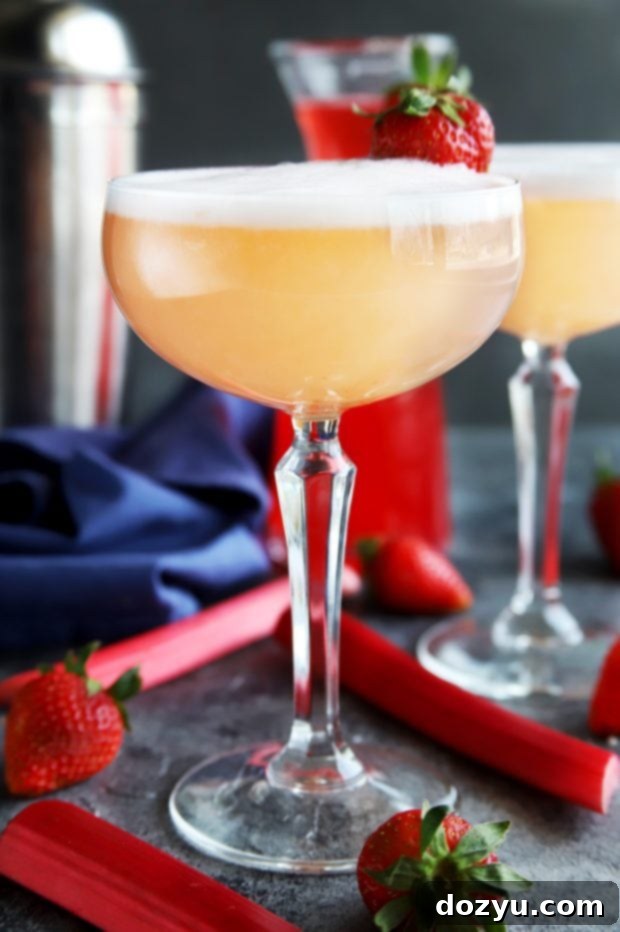Three easy-to-make Strawberry Rhubarb Gin Fizz cocktails, perfect for a spring or summer gathering.