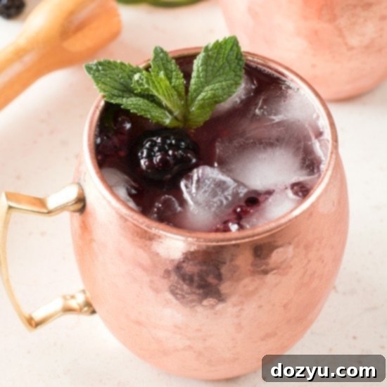 Blackberry Moscow Mule cocktail in a copper mug