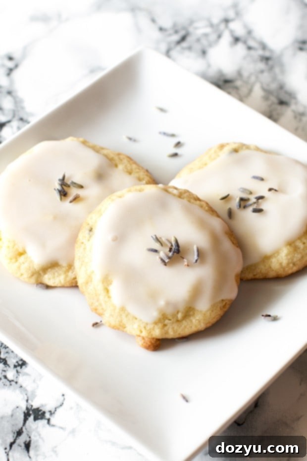 Grandma’s lavender cookies topped with glaze and dried lavender buds on a platter