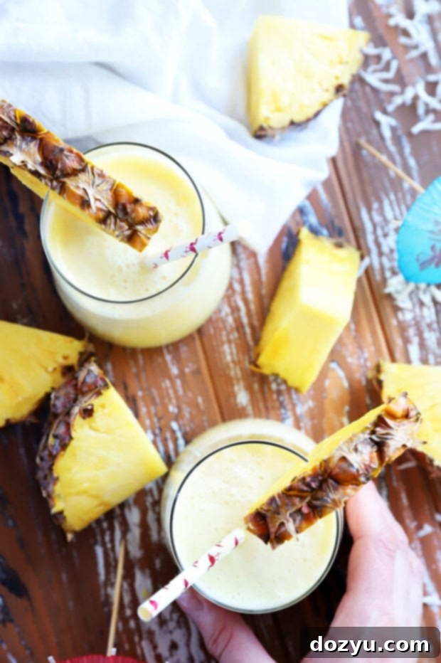 Svelte Piña Colada 7 Hand holding skinny pina colada in glass picture