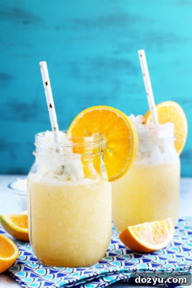 Orange cocktail with whipped cream vodka and whipped cream