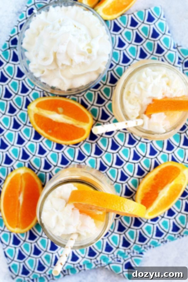 Image of orange cocktails in glasses with whipped cream summer cocktail