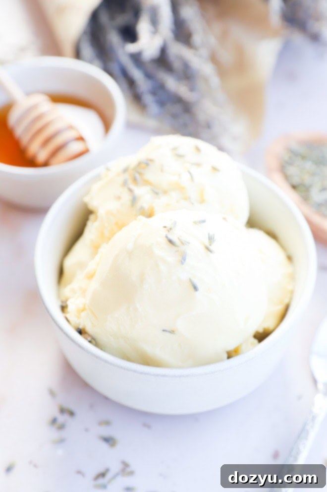 Various ingredients for lavender honey ice cream, including heavy cream, milk, honey, and lavender, neatly arranged in small bowls