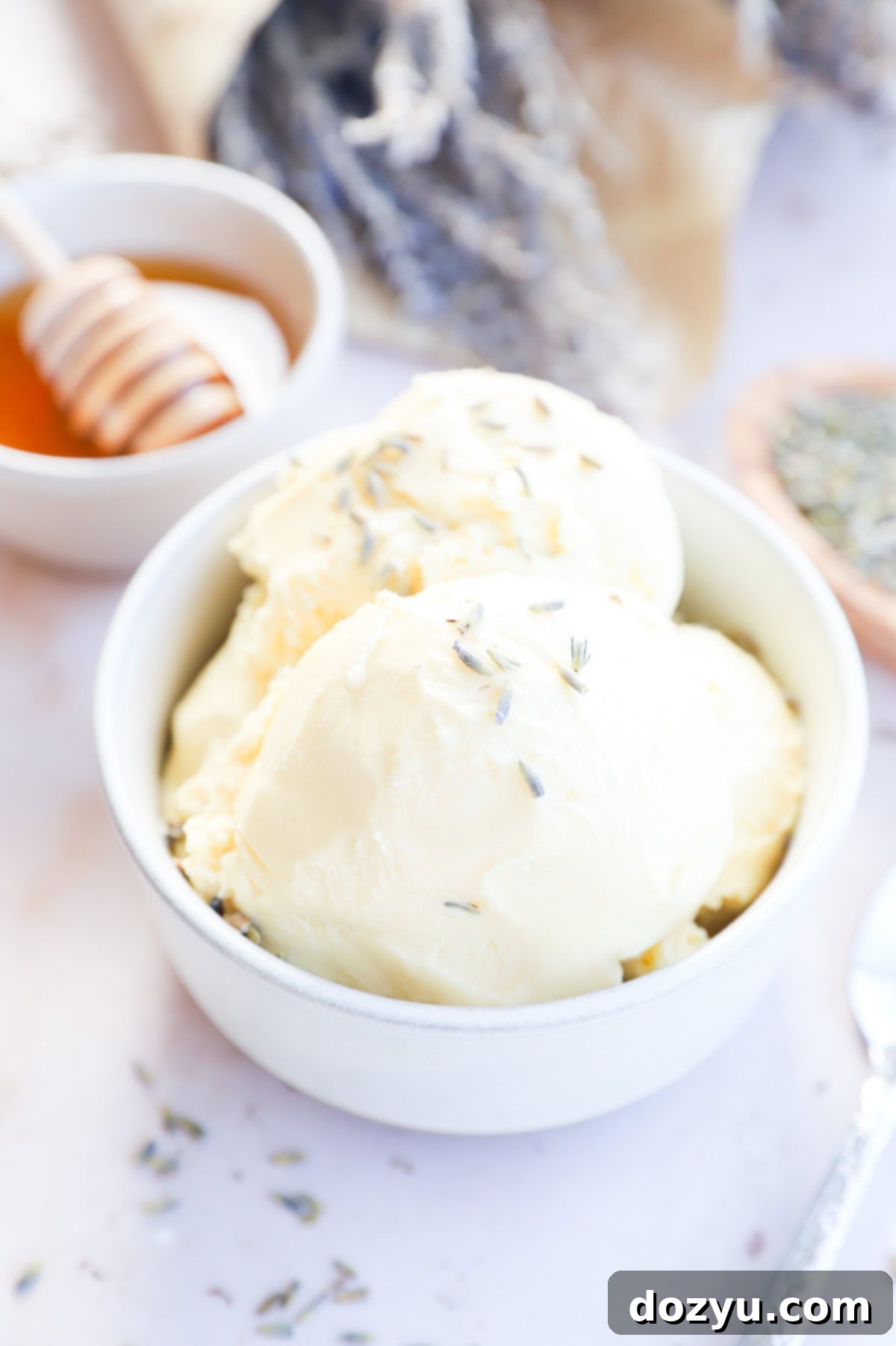 Beautifully scooped lavender honey ice cream in a white bowl, ready to be served