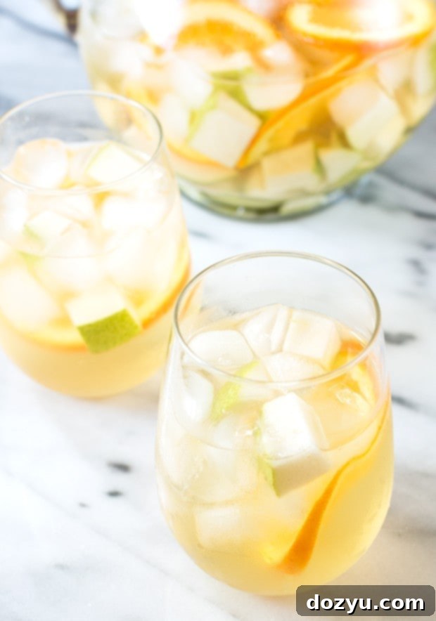 White summer sangria in wine glasses with ice