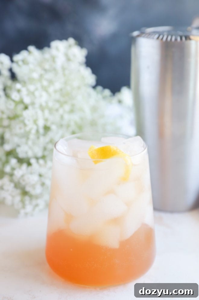 Gin Sling cocktail garnished with a lemon twist