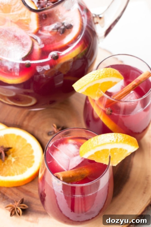 Close-up of Big Batch Holiday Sangria with sliced citrus and spices