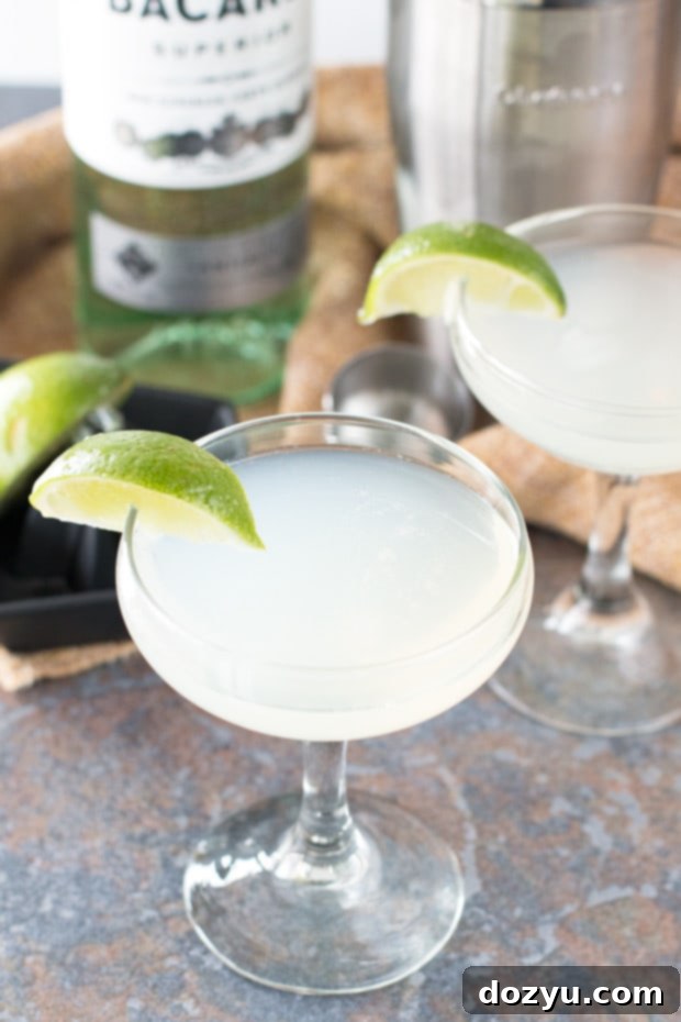 Classic Daiquiri cocktail glass with lime garnish