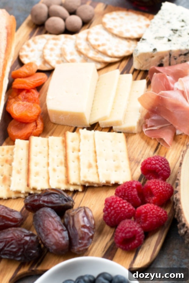 A curated selection of Castello cheeses on a rustic board, alongside berries and nuts for Valentine's Day