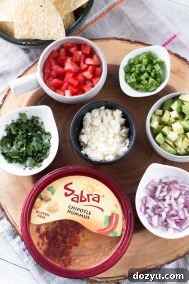 Overhead view of South of the Border Hummus with Sabra Chipotle Hummus, surrounded by colorful tortilla chips, perfect for a casual snack.