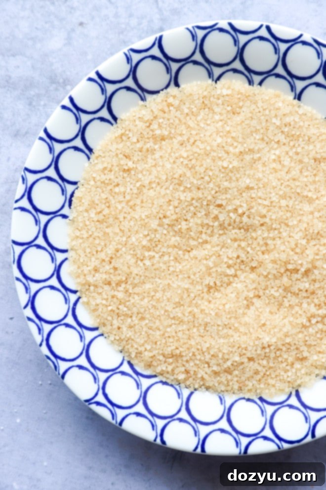 Close-up overhead image of turbinado sugar on a flat plate, ready for glass rimming.
