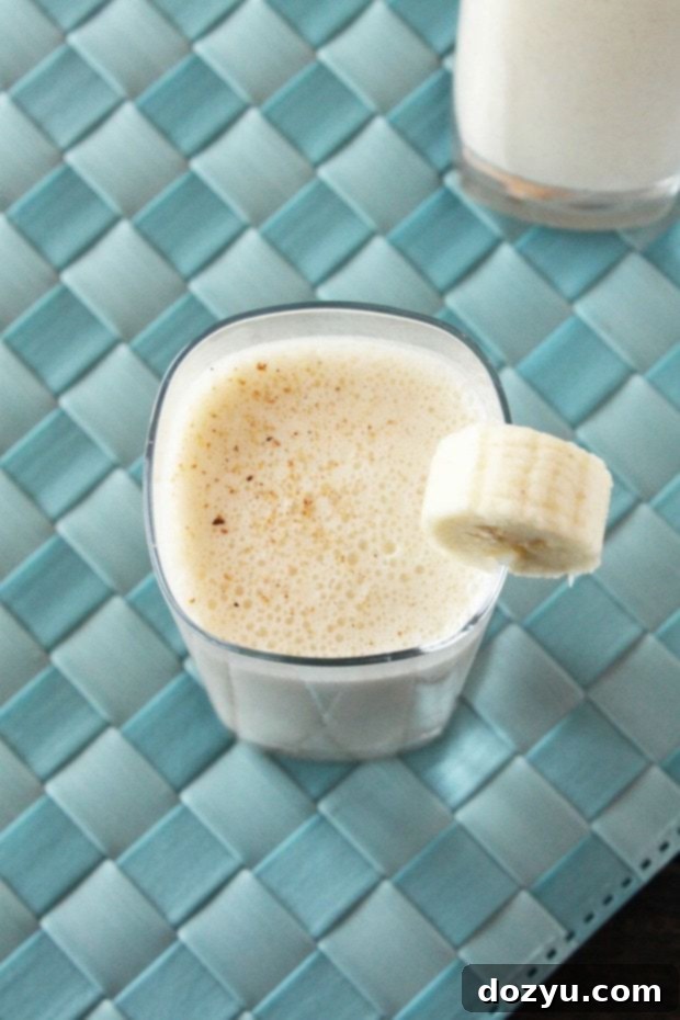 Spiked Caramelized Banana Milkshake 2 Spiked Caramelized Banana Milkshake, garnished with a banana slice and nutmeg.