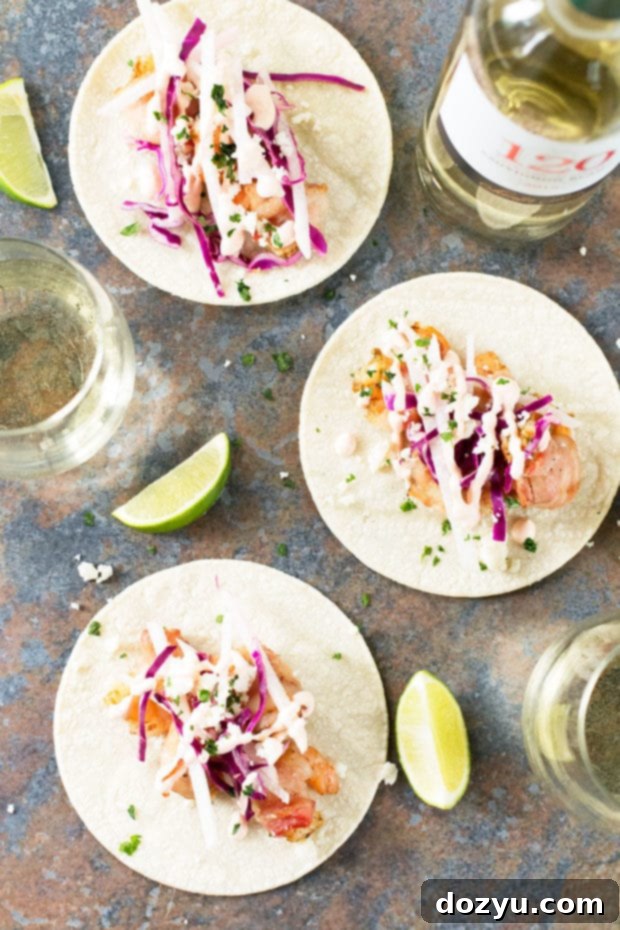 Close-up of a perfectly grilled bacon-wrapped shrimp taco with fresh toppings | cakenknife.com