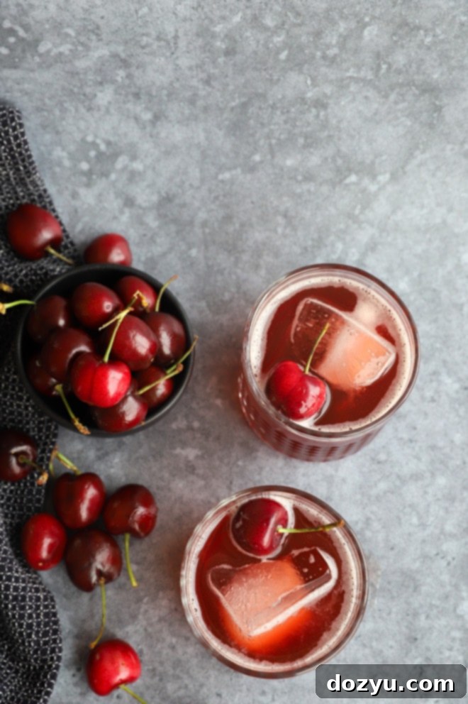 Overhead photo of cocktails in glasses with fresh cherries
