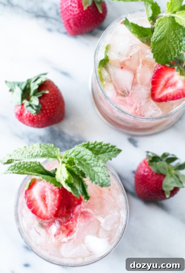 Close-up of a Strawberry Mint Julep with crushed ice, mint, and strawberry slices