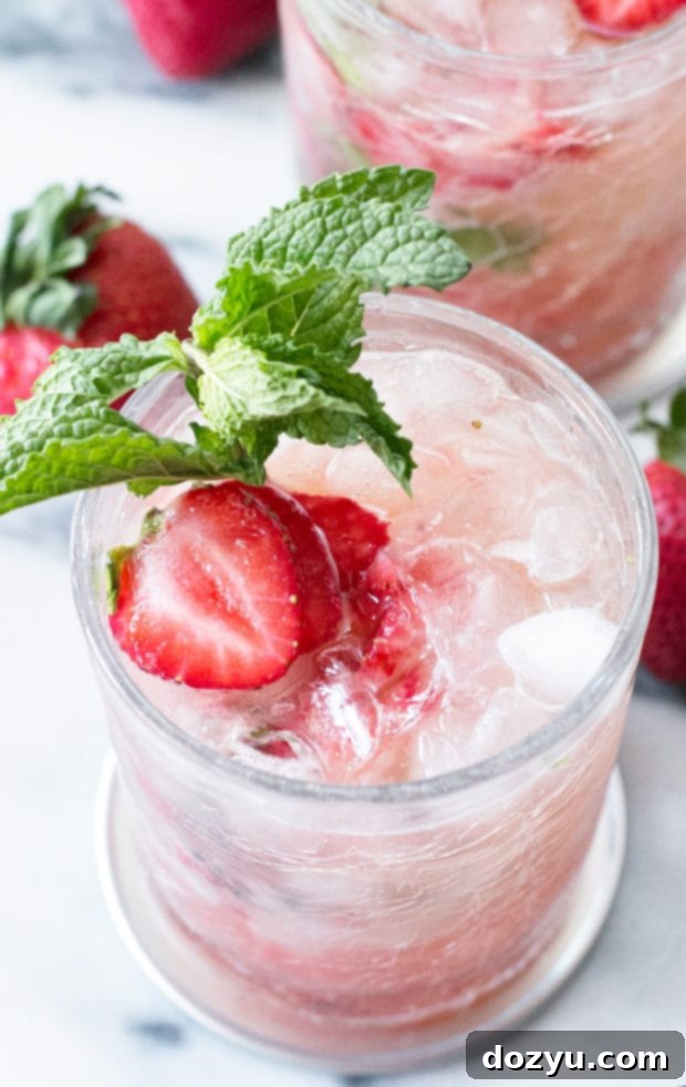 Close-up of a Strawberry Mint Julep with a vibrant red hue