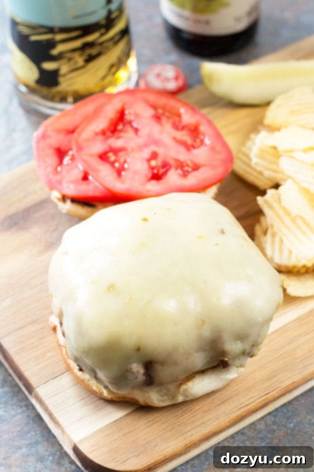 Horizontal view of Bacon-Wrapped Guacamole Burger Bombs, highlighting the melted cheese