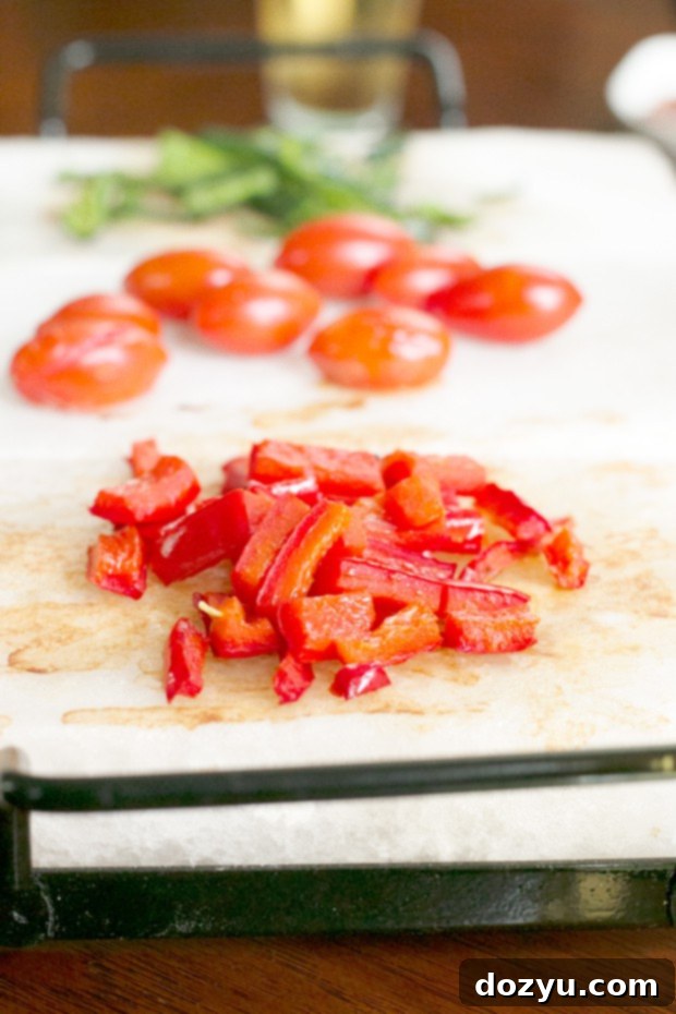 Cooked vegetables on a Himalayan salt plank tray, ready to top pizza