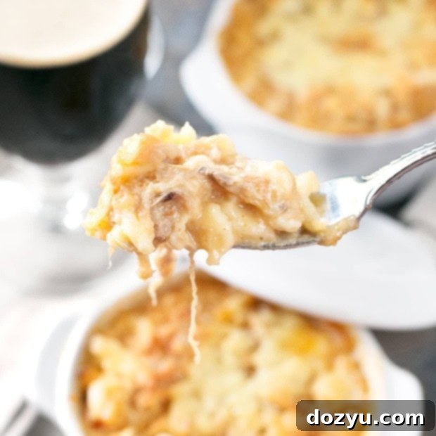 Close-up of Pulled Pork Spaetzle Mac and Cheese with a spoon, highlighting the creamy texture