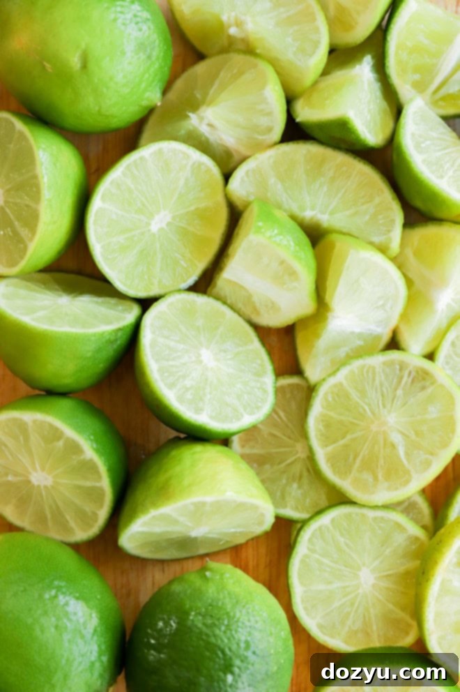 cutting board full of cut up limes and lime wedges
