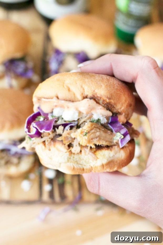 Close-up of a perfectly garnished Cilantro Chili Lime Pulled Pork Slider on a platter