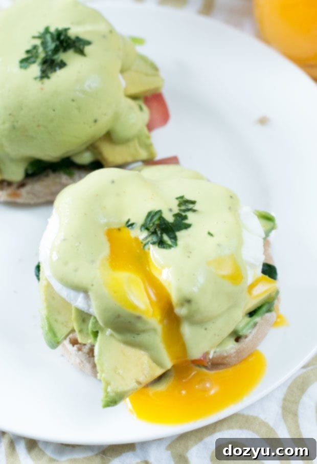 Close-up view of a serving of California-Style Eggs Benedict, ready to be enjoyed.