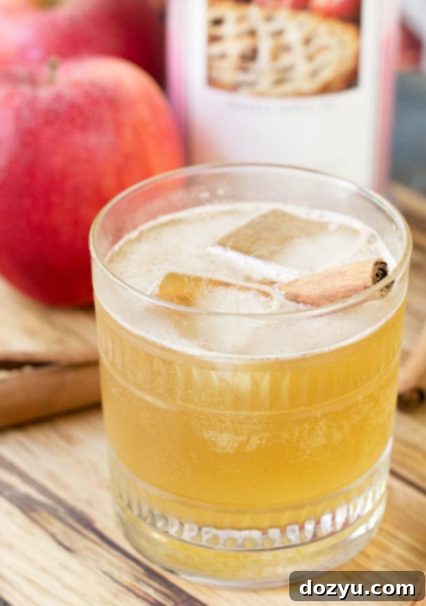 Ingredients for Bourbon Apple Cider Fizz laid out, emphasizing fresh apples and spices.