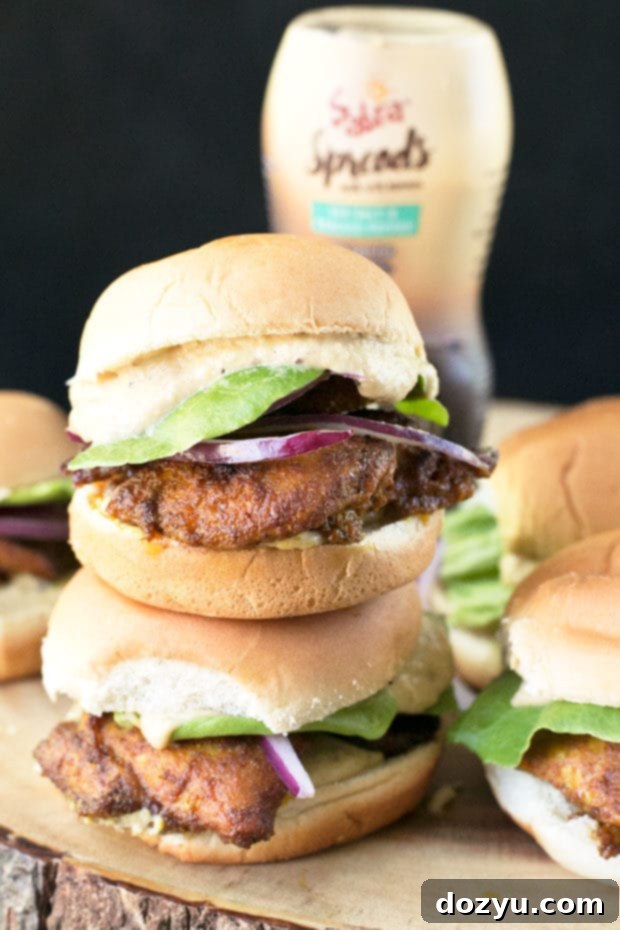 Delicious Chicken Shawarma Sliders topped with Sabra Sea Salt & Cracked Pepper Spread, served on a platter. Perfect party food.