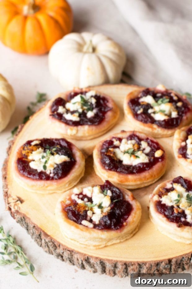 Ruby Red & Creamy Bites 5 Ingredients for cranberry goat cheese tarts laid out: puff pastry, cranberry sauce, orange zest, goat cheese, and fresh thyme.