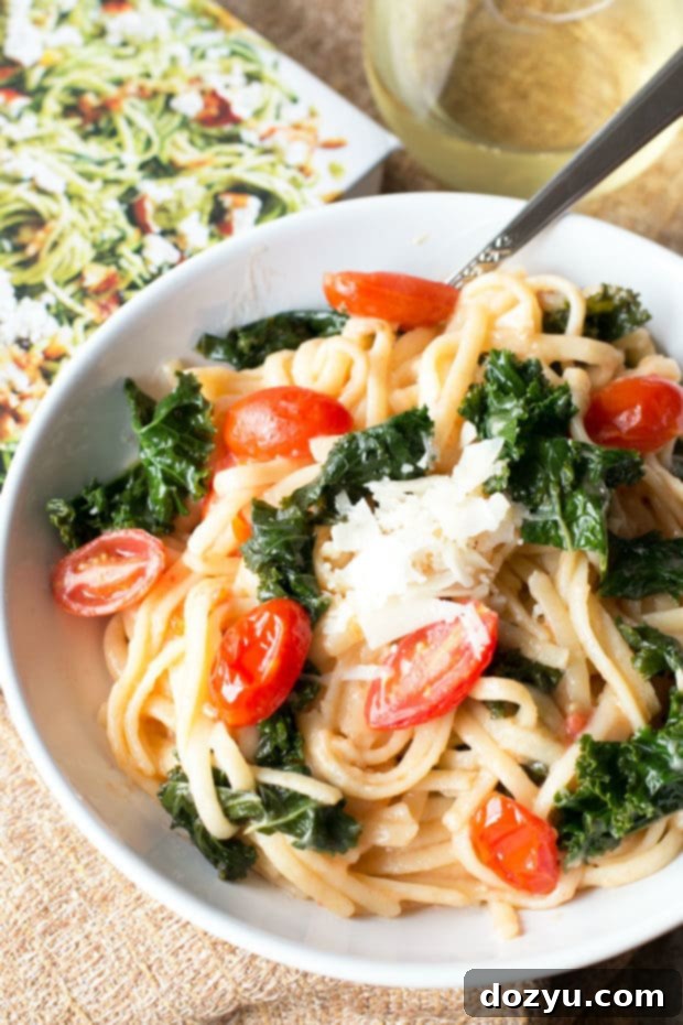 Exploring A Modern Way to Cook and its Kale Tomato Lemon Magic One Pot Spaghetti 5 A bowl of freshly cooked One-Pot Kale, Tomato, and Lemon Spaghetti garnished with Parmesan