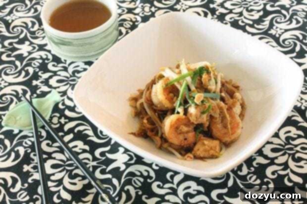 Plated Pad Thai garnished with peanuts and lime