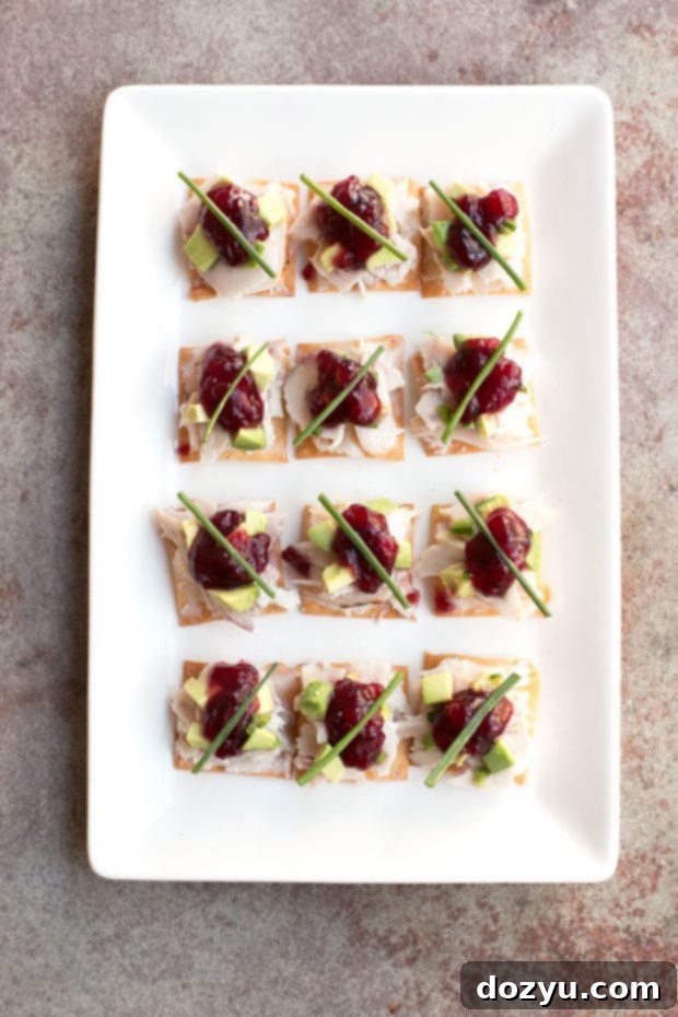 Close-up of a single Thanksgiving Leftover Bite, showcasing layers of turkey, mashed potatoes, and cranberry