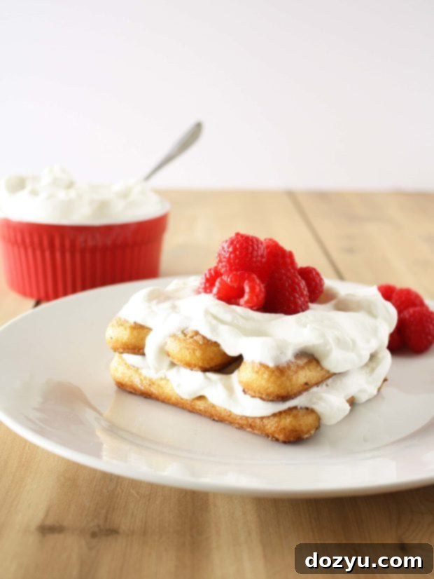 Delicious Ladyfinger French Toast topped with whipped cream and fresh raspberries
