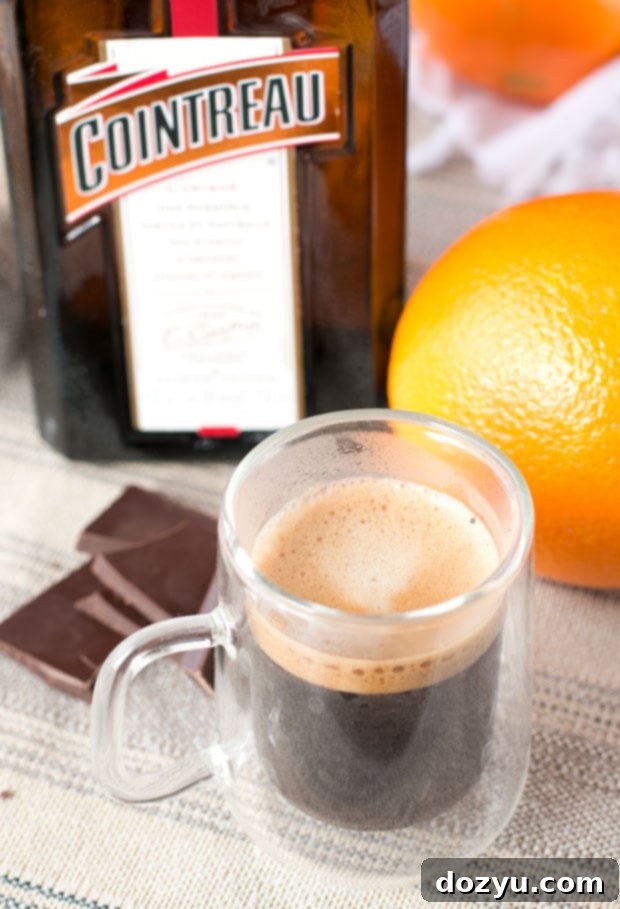 Delicious Hot Orange Mocha Cocktail garnished with a rich swirl of espresso whipped cream