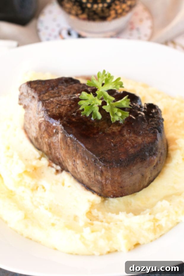 Filet Mignon with Port Wine Reduction and Truffled Potatoes 3 Close-up of a tender Filet Mignon steak drizzled with rich, glossy Port Sauce, highlighting its succulent texture and the elegant presentation of this gourmet dish.