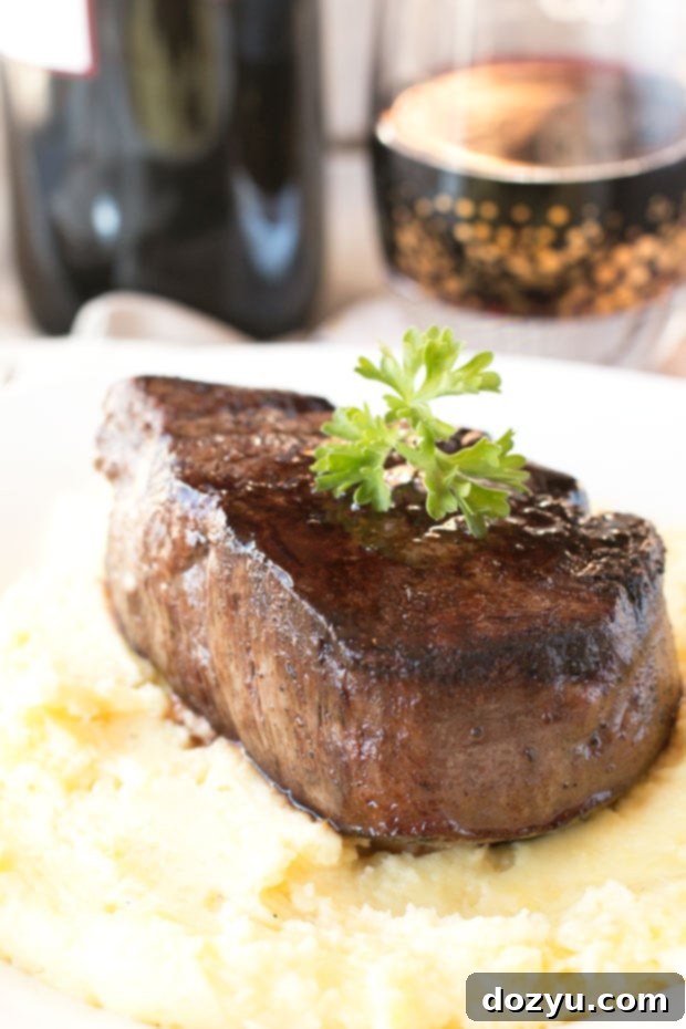 Filet Mignon with Port Wine Reduction and Truffled Potatoes 4 A beautifully plated Filet Mignon dinner, showcasing a thick cut of steak resting on a bed of fluffy Truffle Mashed Potatoes, generously coated in a dark Port Wine Sauce.