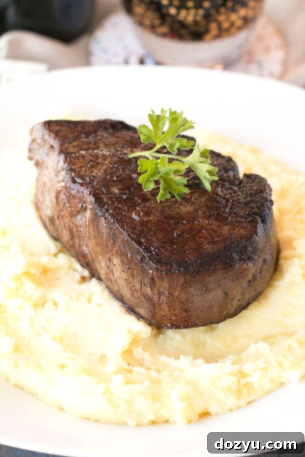 Filet Mignon with Port Wine Reduction and Truffled Potatoes 5 Overhead view of a gourmet Filet Mignon dish, showcasing the tender steak, rich port sauce, and creamy truffle mashed potatoes, elegantly plated for a festive meal.