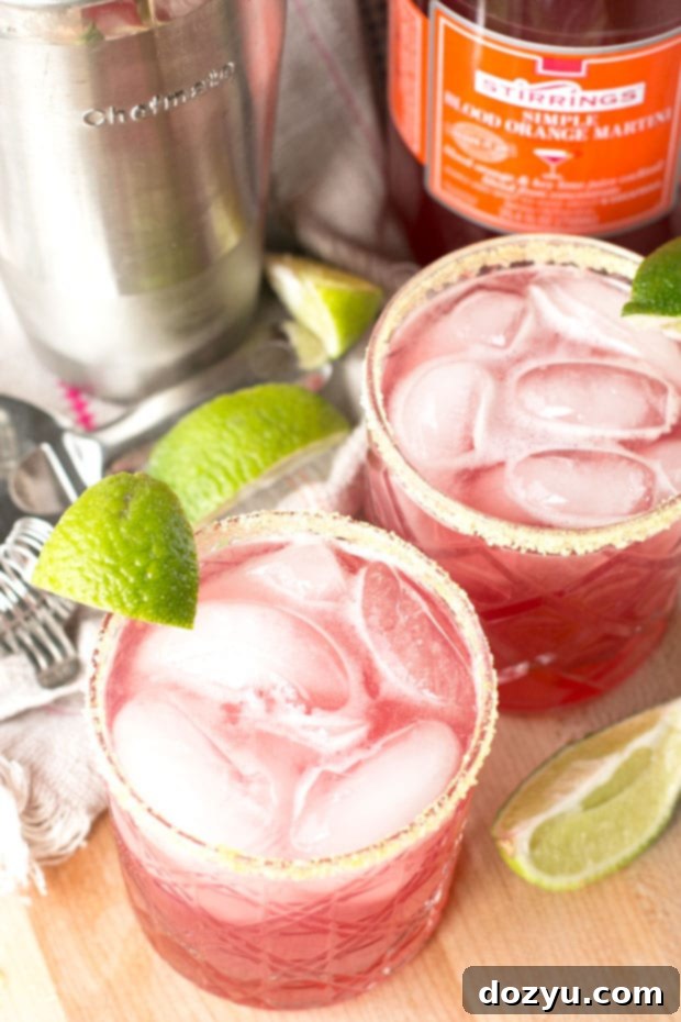 Bright and colorful Winter Citrus Margarita with blood orange, lemon, and lime garnish, perfect for a cozy evening.