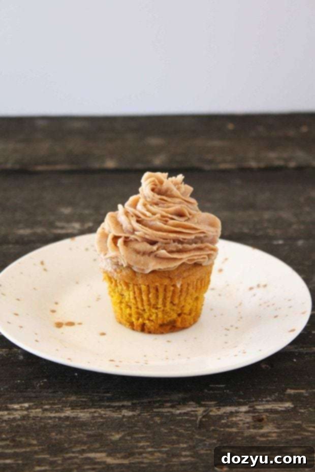Close-up of a festive pumpkin cupcake with frosting