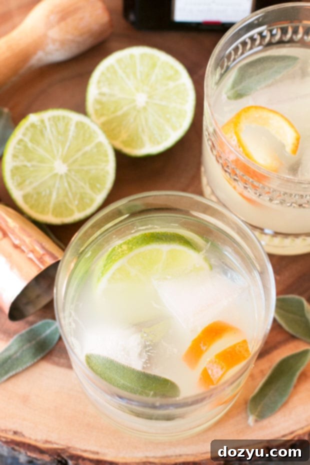 Muddling lime and sage for a Tequila Sage Smash cocktail