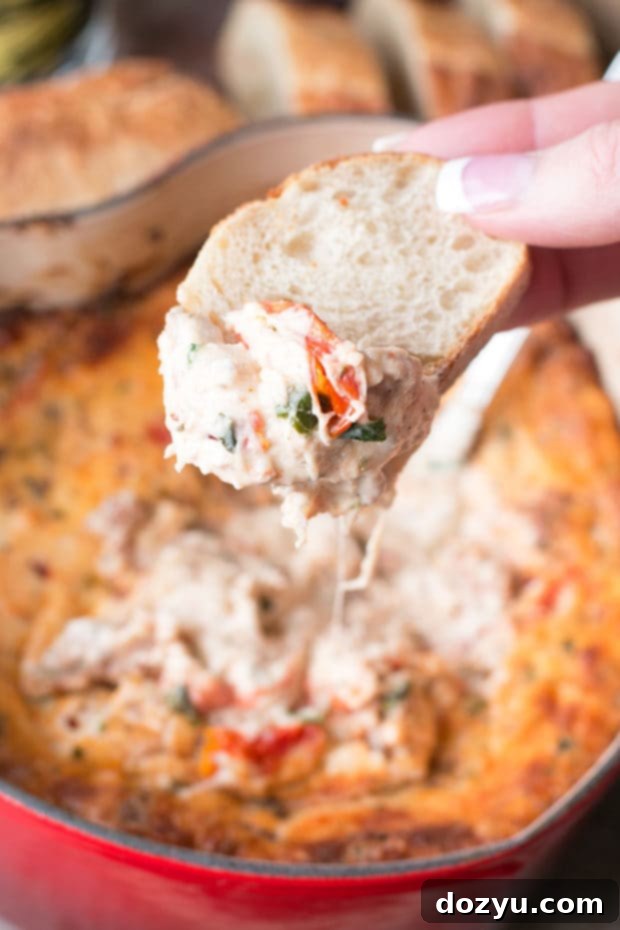 Rich and creamy Spicy Lasagna Dip brimming with tomatoes, a variety of cheeses, fresh herbs, and savory spicy Italian sausage. A perfect no-noodle alternative.