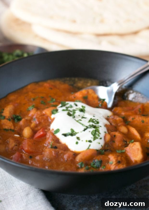 A serving of Tikka Masala Chicken Chili with fresh lime and cilantro. #soup #dinner #recipe