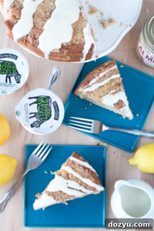 Slice of Almond Butter Yogurt Coffee Cake, showcasing the moist interior and fluffy frosting.