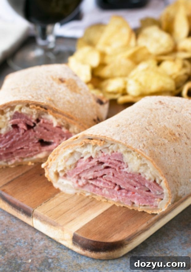 Ingredients for Irish Corned Beef Reuben Wraps laid out: Flatout Flatbreads, shredded Swiss cheese, warmed corned beef, sauerkraut, and a bowl of creamy stout spread.