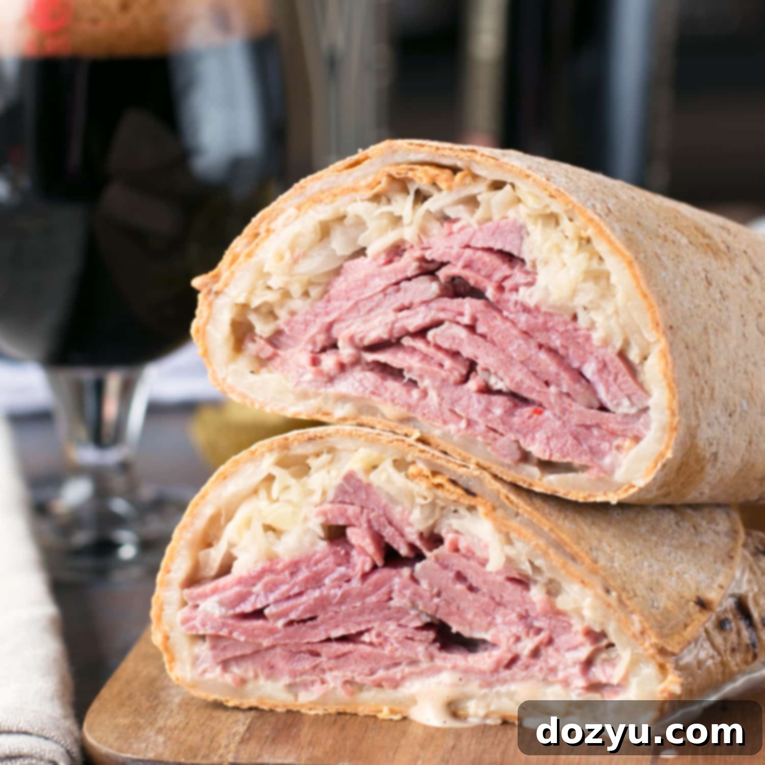 Close-up of a deliciously assembled Irish Corned Beef Reuben Wrap, highlighting the golden brown flatbread and vibrant fillings.
