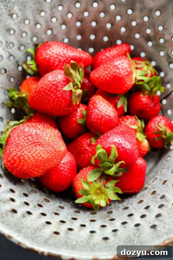 fresh strawberries in a colander after being washed